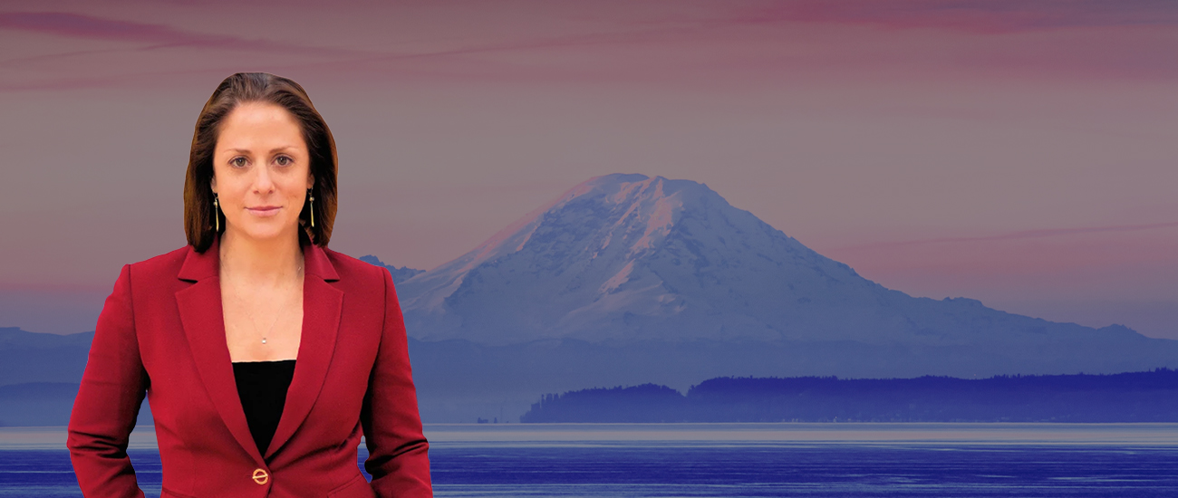 Attorney in a red blazer with a scenic view of Mount Rainier in the background